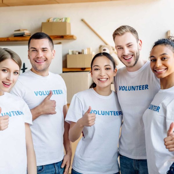 five-young-multicultural-volunteers-showing-thumbs-up-smiling-and-looking-at-camera.jpg